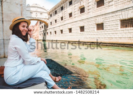woman sitting at city quay at venice italy enjoying the view of canals copy space