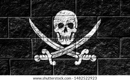 Flag of Pirates black close up painted on a cracked wall