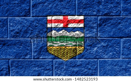 Flag of Alberta close up painted on a cracked wall