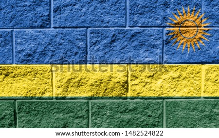 Flag of Rwanda close up painted on a cracked wall
