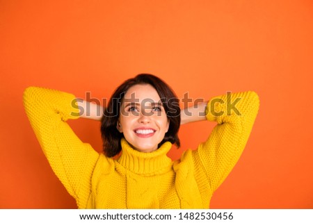 Close up photo of beautiful dreaming girl planning something waiting it to happen while isolated with orange background