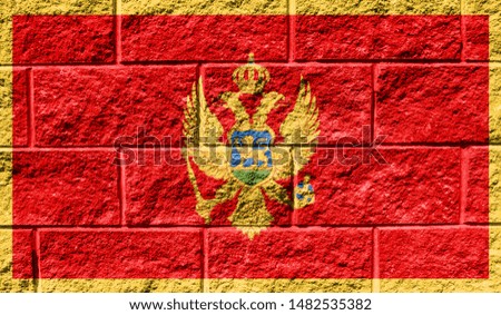 Flag of Montenegro close up painted on a cracked wall