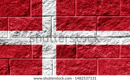 Flag of Denmark close up painted on a cracked wall