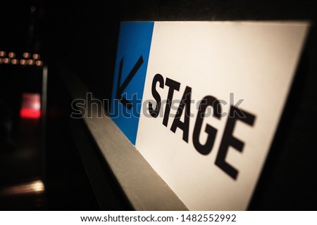 Stage sign for performer in night club on backstage. Arrow showing direction on scene entrance in music hall. Entertainment event background