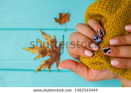 luxury sort of pink  manicure on the blue background. cozy autumn nails. place fo text. Royalty-Free Stock Photo #1482563444