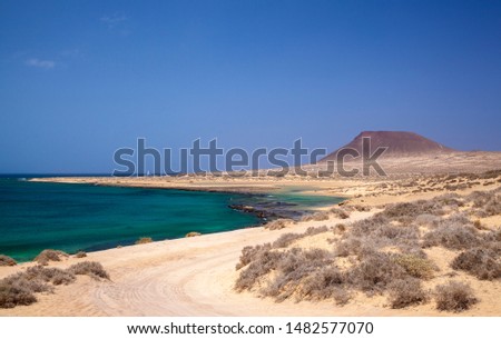 La Graciosa island, part of Chinijo Archipelago, close to Lanzarote, view towards Montana Amarilla, Yellow mountain, over shallow waters of Bahia del Salado