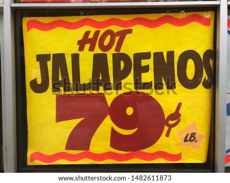 Old fashioned hand painted store sign offering hot jalapenos at a cheap price