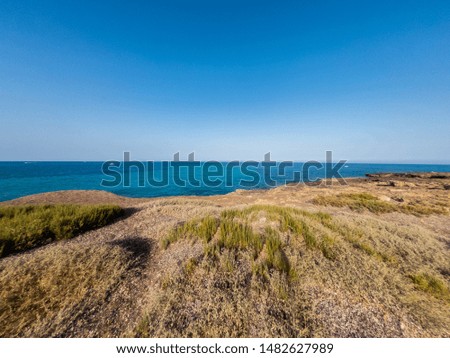 View of the beautiful San Lorenzo rock beach, in the southern Sicily, Italy. The shot is takend during a sunny summer day