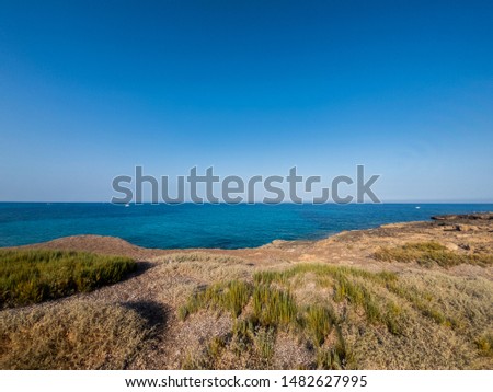 View of the beautiful San Lorenzo rock beach, in the southern Sicily, Italy. The shot is takend during a sunny summer day