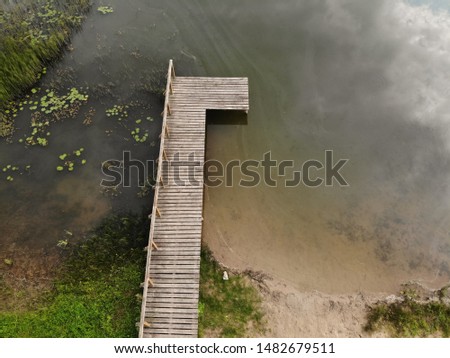 Aerial view of wooden bridge to the natural lake in Lithuania