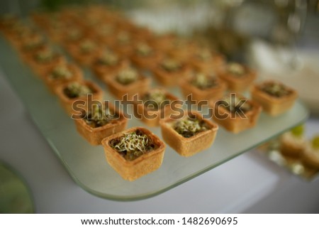 Snacks on glass trays. Canapes and tartlets appetizers.