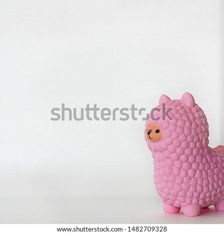 Pink small llama squishy on white empty background. Square with copy space. Isolate. Soft toy for kids, antistress.