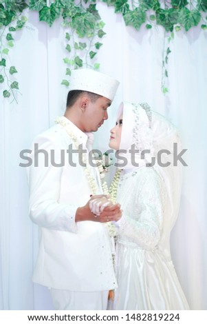 Wedding day bride and Groom showing their love in an indoor wedding. In love concept. Happily ever after. Ijab Qabul or Moslems groom's proposal and bride's acceptance parts known as the Ijab-e-Qubul.