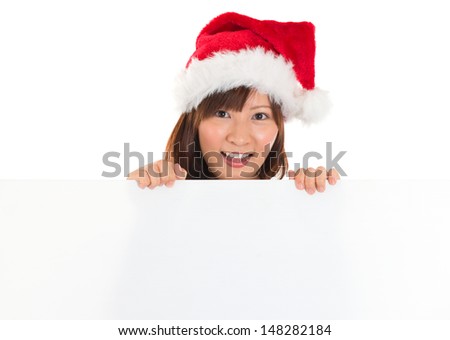 Christmas girl with sign. Beautiful mixed race Asian Chinese / Japanese  woman with billboard looking surprised. Isolated on white background.