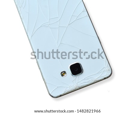 The back of the mobile phone has cracks. Isolated on white background