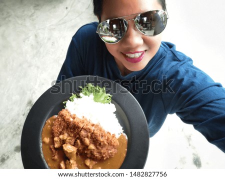 Woman happy smile taking a selfie and curry rice and fried pork