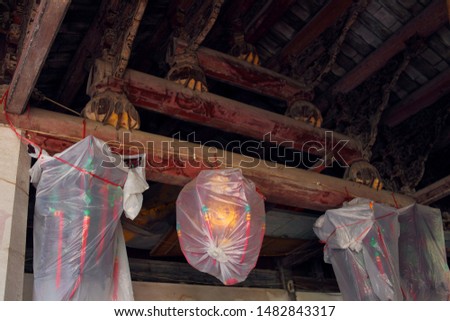 In the traditional Chinese countryside, there will be a temple, with timber architecture, carving and painting historical Buddhist motifs on the eaves and beams, and hanging lanterns.