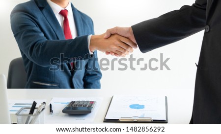 success dealing, two people shake hand as cooperate and teamwork to success in business and financial, greeting and partner concept.