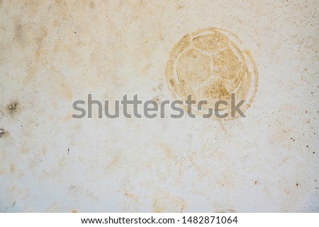 Football print on cement background,soccer slough on wall
