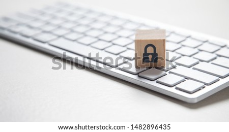 Padlock symbol on wooden block. Computer keyboard