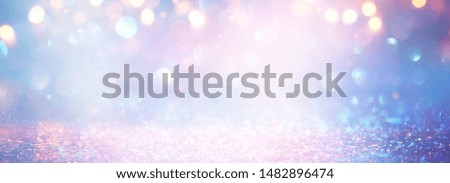 background of abstract glitter lights. blue, pink, gold and silver. de focused. banner