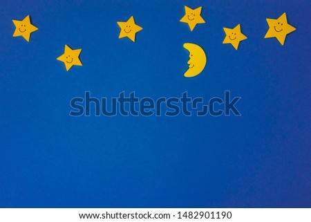 Crescent moon and yellow stars against the blue night sky. Application paper. Copy space