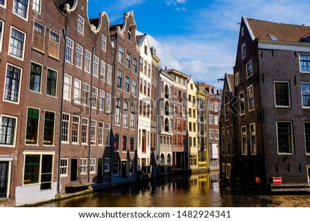View of the Famous Amsterdam Channel with Colorful Floating Buildings and Beautiful Blue Sky. 
