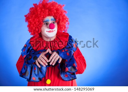 Clown on blue backgound studio inside shot