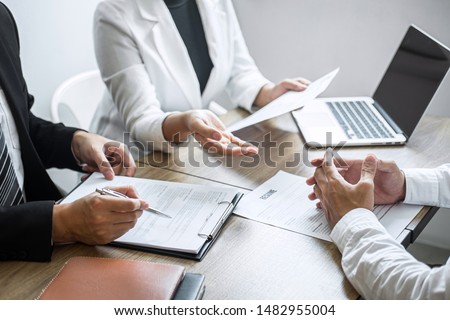 Employer or committee holding reading a resume with talking during about his profile of candidate, employer in suit is conducting a job interview, manager resource employment and recruitment concept. Royalty-Free Stock Photo #1482955004