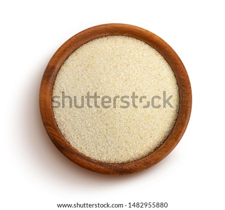 Semolina isolated on white background, raw semolina porridge in rustic wooden bowl, top view Royalty-Free Stock Photo #1482955880