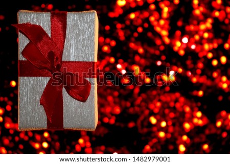  beautiful gift with red bow on shiny background