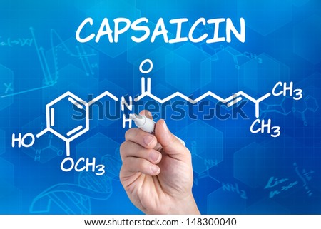 hand with pen drawing the chemical formula of capsaicin