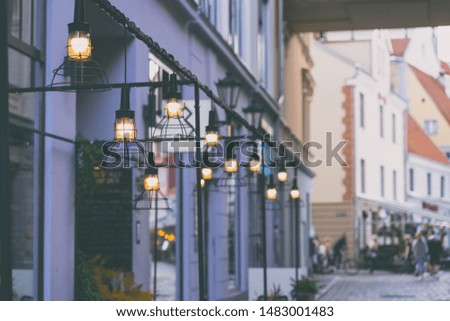 Street summer life of the old Riga in the evening with open-air cafes and restaurants