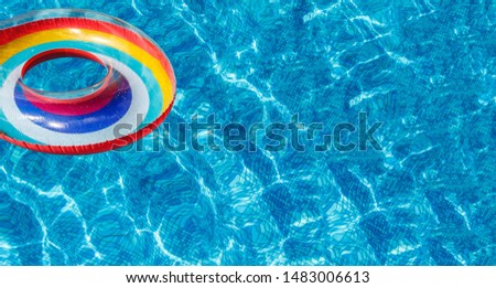 Inflatable water activities circles tuba float on the water in the pool. Concept, fun, perky summer and relaxation