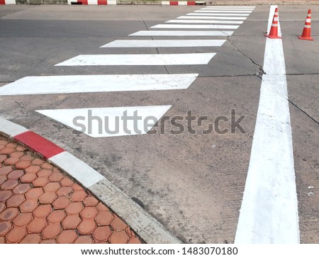 Empty Crosswalk on concrete road for people crossing at Thailand.
