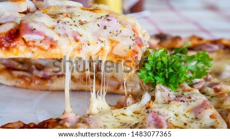 Family lunch eating pizza ham cheese recipe - people with favour italian dish concept Royalty-Free Stock Photo #1483077365