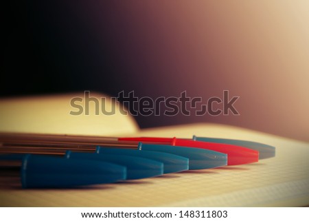 Pens on a opened book. Abstract image. 