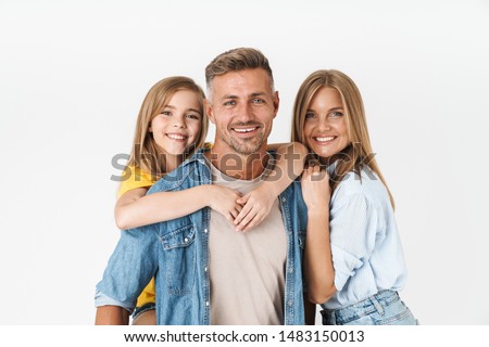 Photo of adorable caucasian family woman and man with little girl smiling and posing together at camera isolated over white background