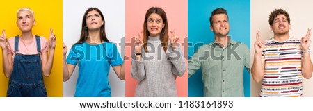 Set of people over colorful backgrounds with fingers crossing and wishing the best