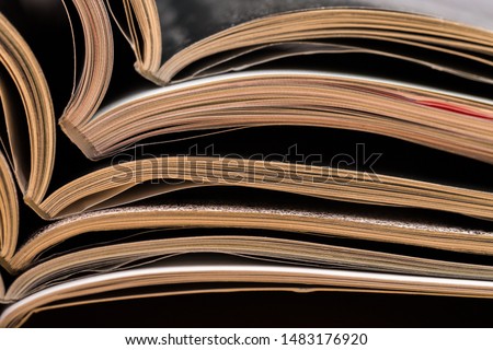 Colorful abstract background image of stacked magazines on wooden table