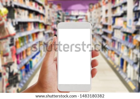 Hand holding White Smartphone for online shopping concept.    