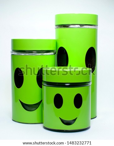 three green glass jar with a smile icon