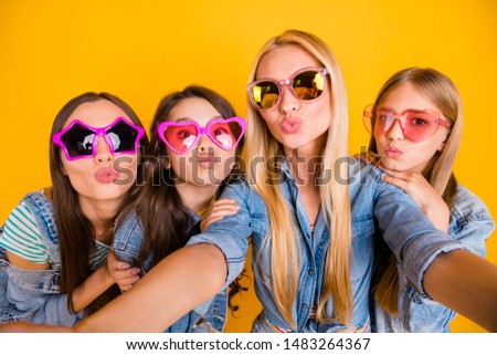 Close up photo portrait of four charming nice cheerful sweet dreamy lovely girls taking picture in modern denim outfit isolated vivid background