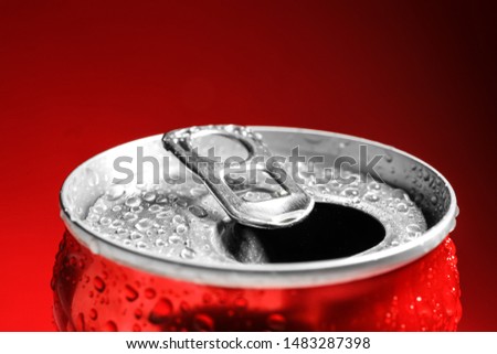Wet open can on red background, closeup