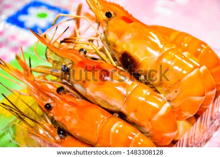 Seafood food: Prawns burned in large amounts  Served on a wooden tray on a street food market in Thailand - Southeast Asia