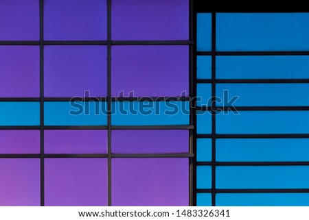 Modern Office Building with Blue and Purple Windows and Geometric Patterns