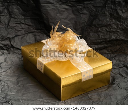 Gold gift box on black background