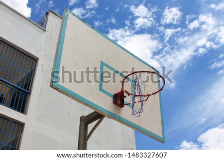 basketball board of a school under a blue sky