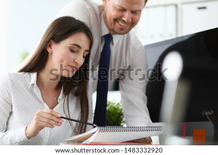 Portrait of businesslady correcting mistakes with client. Beautiful designer speaking abut edits with customer. Business and art designing concept. Blurred background