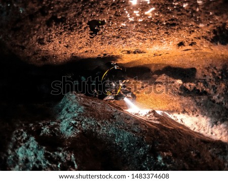 scuba diver exploring a cave
